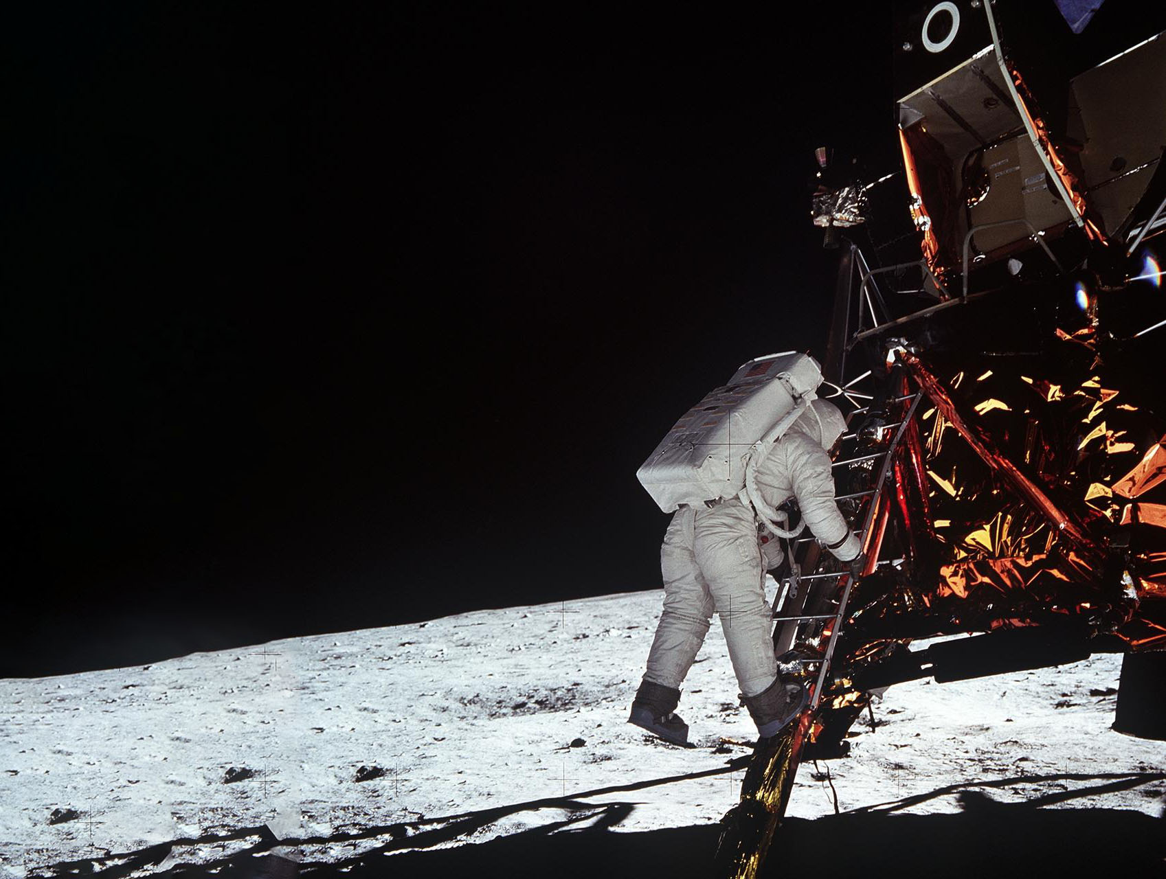 Astronaut Edwin Aldrin descends steps of Lunar Module ladder to walk on moon